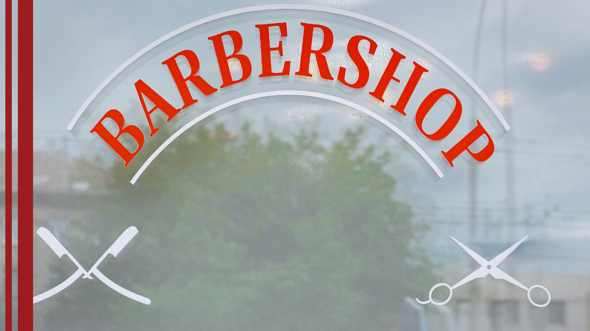 A frosted window at the barbershop displays the shop name and the barbershop rules.