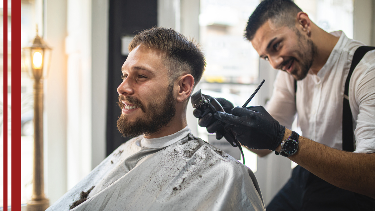 business-plan-barber-2026 A client gets his hair cut while his barber discusses the 2026 Barbershop business plan.