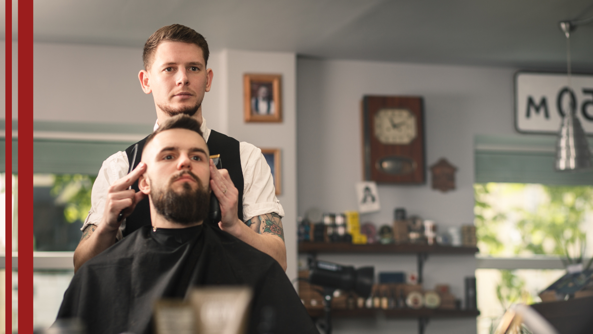 A barber ponders the barber's SEO best practice while he cuts his client's hair.